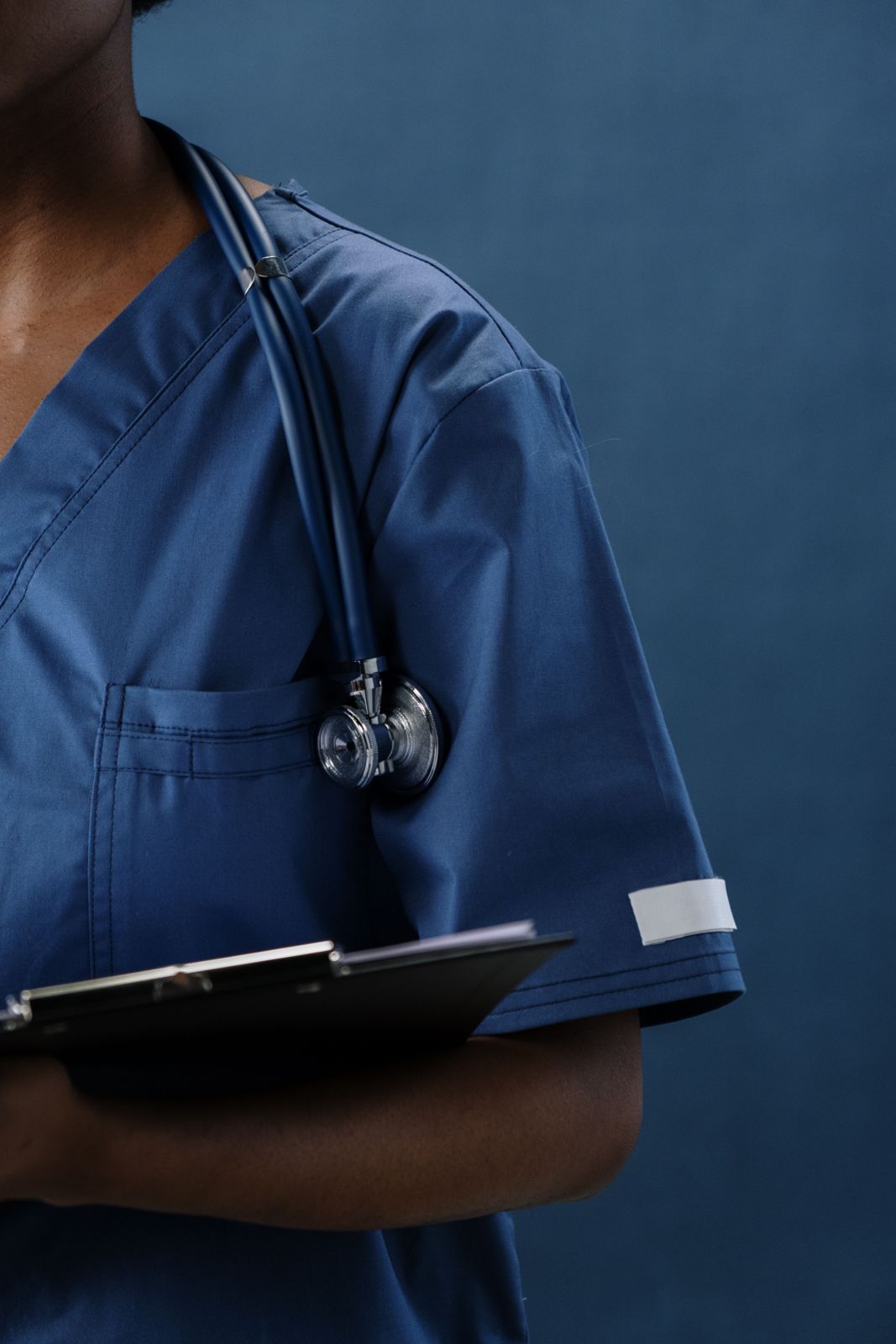 Collector in scrubs holding a clipboard