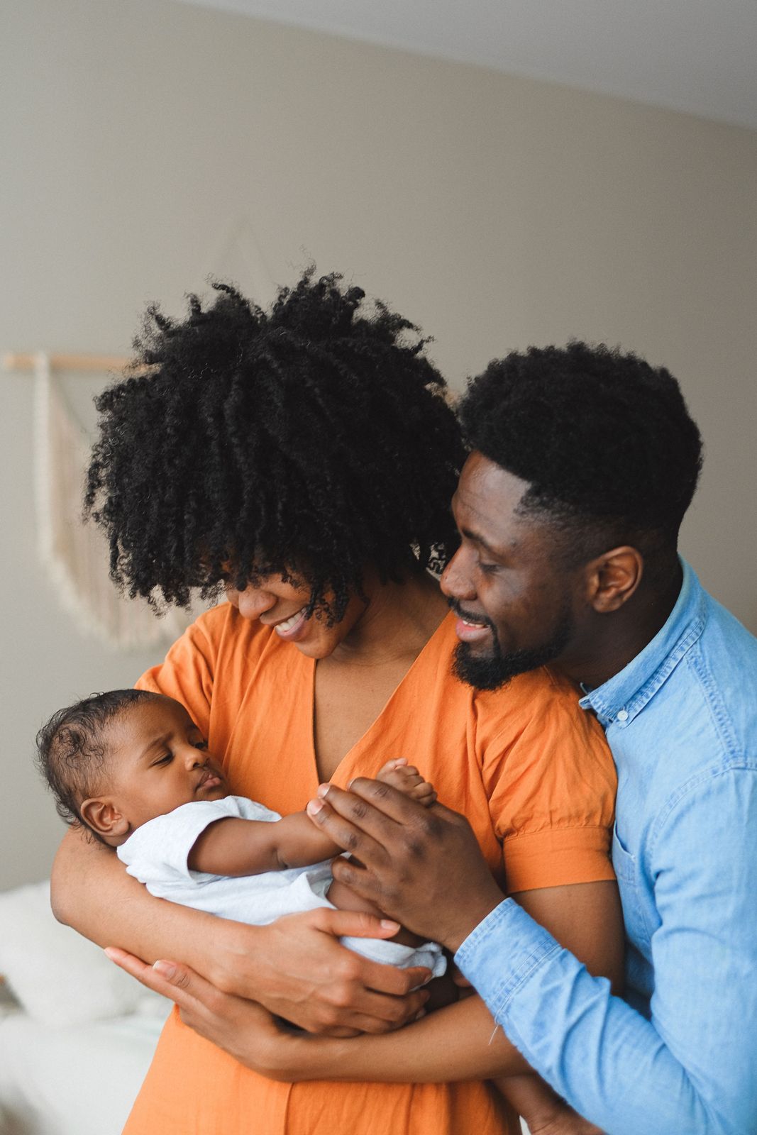 Mother and father holding their newborn